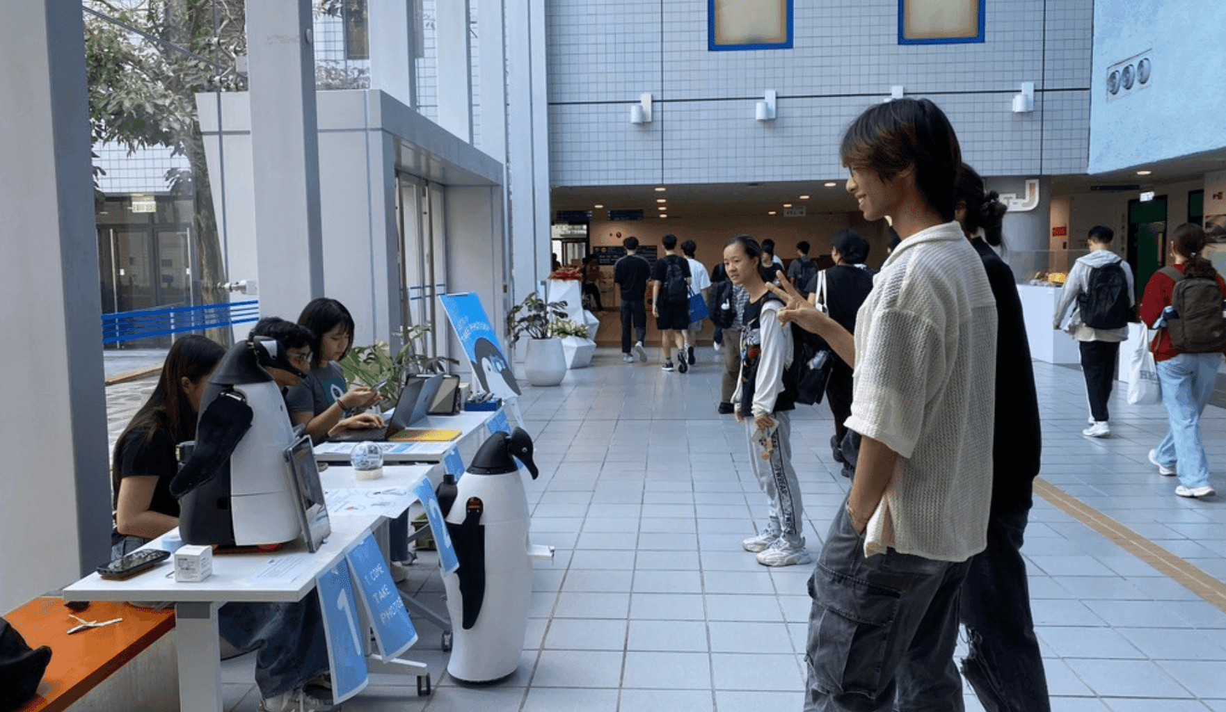 Visitors interacting with PANGUAN at an exhibition booth